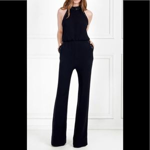 Black high neck jumpsuit with sequin details.